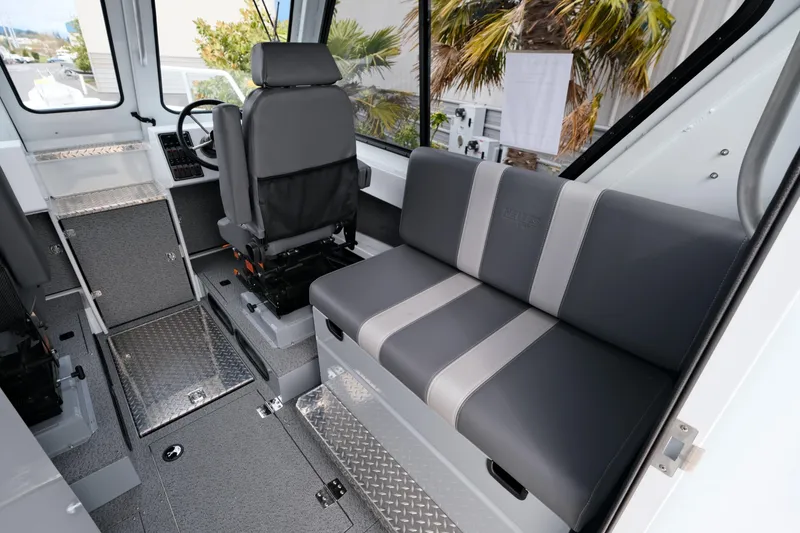 Slide: The Image of Interior of 2025 Hewescraft 250 Alaskan boat with seating and steering area. - 12