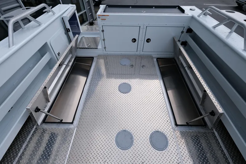 Slide: The Image of 2025 Hewescraft 250 Alaskan boat interior with storage compartments and diamond plate flooring. - 19
