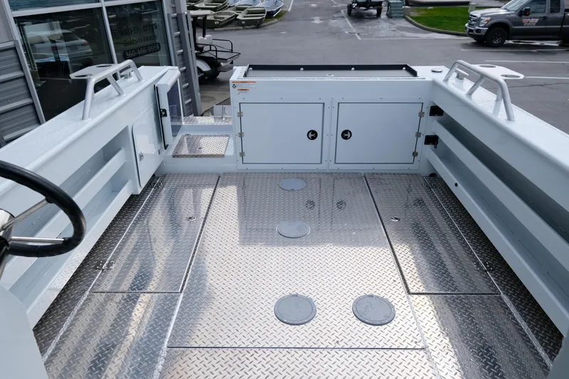 Slide: The Image of 2025 Hewescraft 250 Alaskan boat interior with diamond plate flooring and storage compartments. - 8