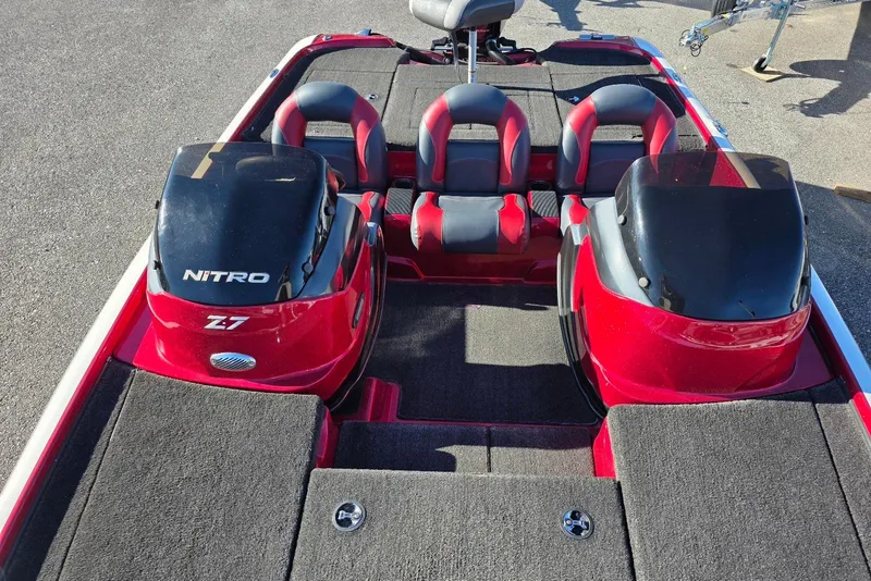 Slide: The Image of 2014 Nitro Z-7 boat interior with red and black seating and carpeted deck. - 15