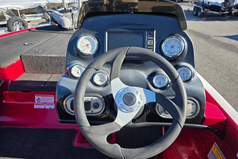 Slide: The Image of Steering console of a 2014 Nitro Z-7 boat with gauges and controls. - 17