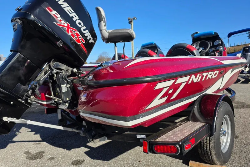 Slide: The Image of Red 2014 Nitro Z-7 boat with Mercury Pro XS engine, parked on a trailer. - 5