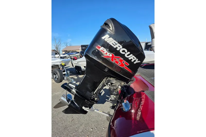 Slide: The Image of 2014 Nitro Z-7 boat with Mercury Pro XS outboard motor in a parking lot. - 6