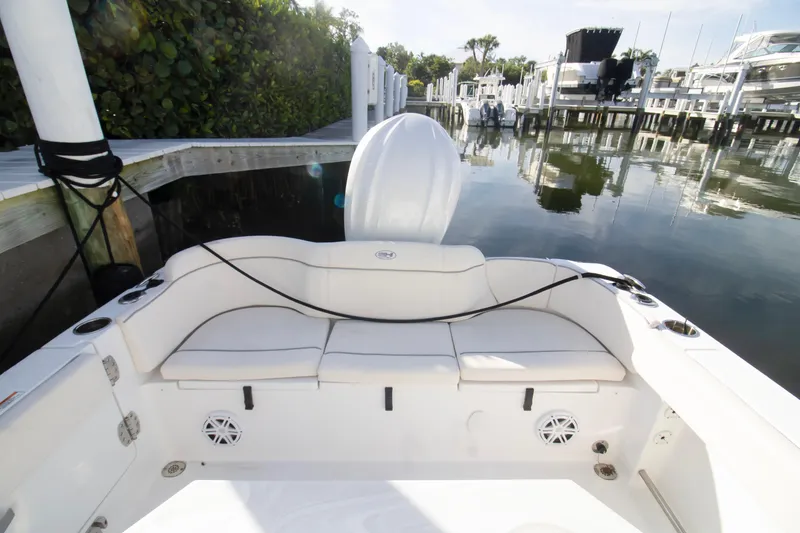 Slide: The Image of 2026 Sea Hunt Ultra 245 SE boat interior at a marina dock. - 4