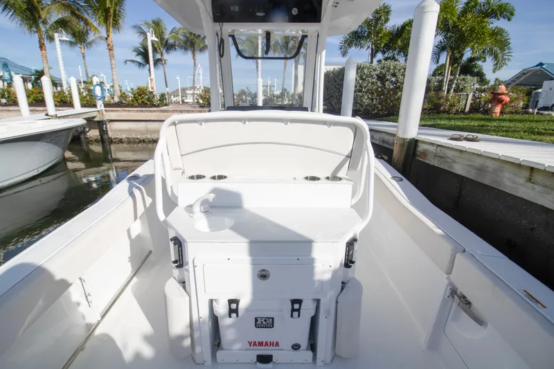Slide: The Image of 2026 Sea Hunt Ultra 245 SE boat interior at a sunny marina dock. - 5