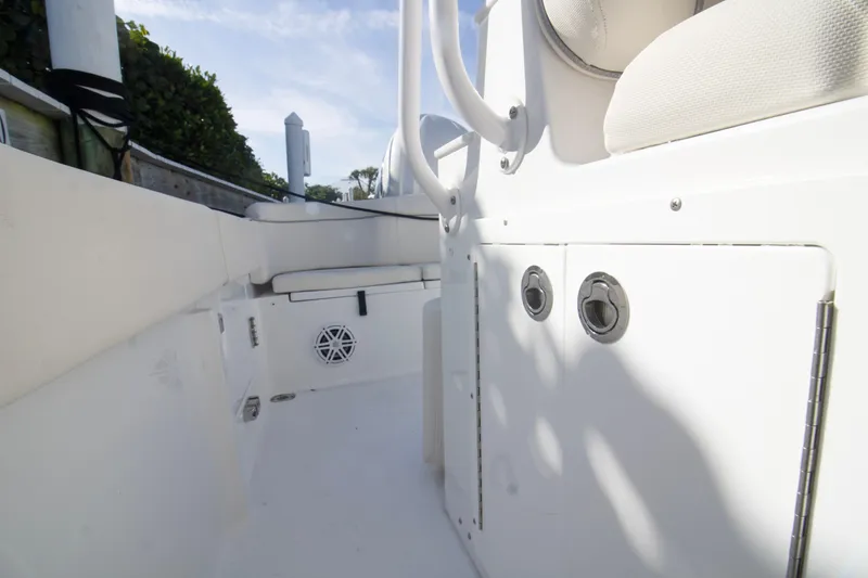 Slide: The Image of 2026 Sea Hunt Ultra 245 SE boat interior, featuring white seating and storage compartments. - 7