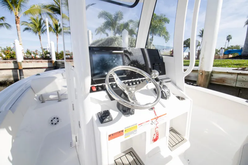 Slide: The Image of 2026 Sea Hunt Ultra 245 SE boat cockpit with steering wheel and control panel. - 9