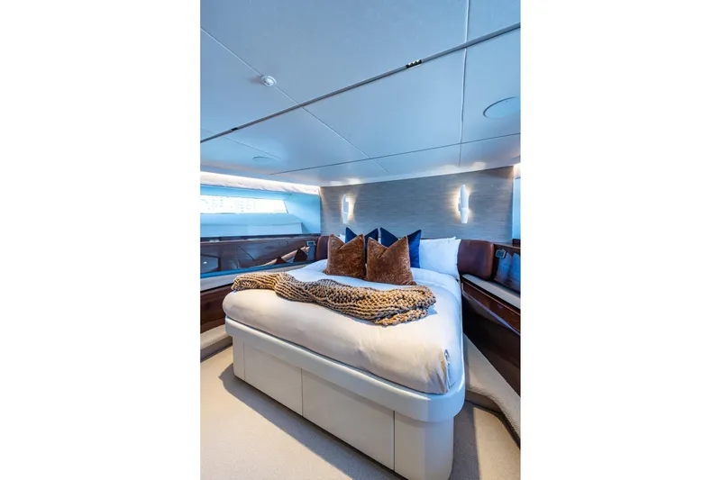 Slide: The Image of Luxurious bedroom interior on 2022 Princess X95 yacht, featuring elegant bedding and modern lighting. - 100