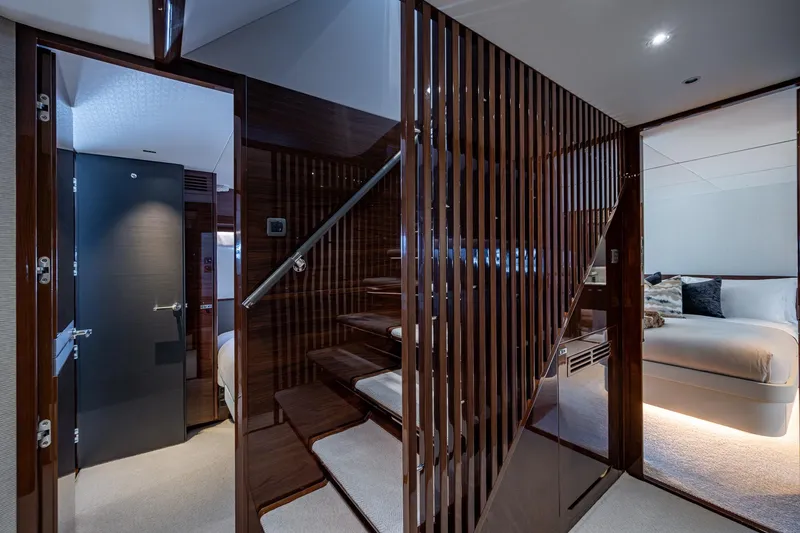 Slide: The Image of Luxurious interior of 2022 Princess X95 yacht featuring elegant staircase and cozy bedroom. - 108