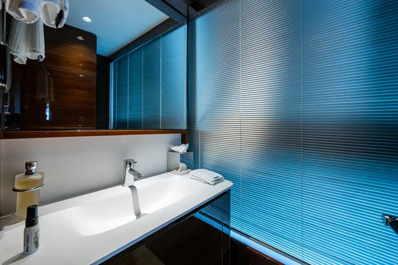 Slide: The Image of Luxurious bathroom interior of 2022 Princess X95 yacht with modern sink and ambient lighting. - 129