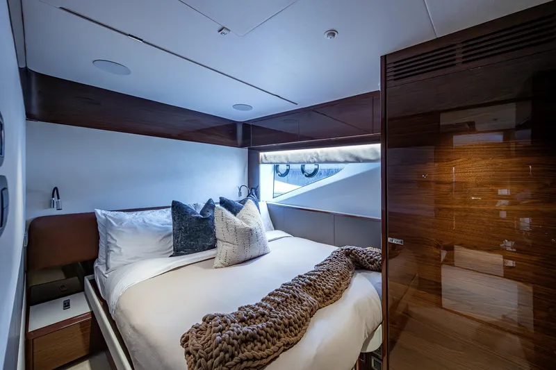Slide: The Image of Luxurious bedroom interior of 2022 Princess X95 yacht with elegant wood finishes and cozy bedding. - 130