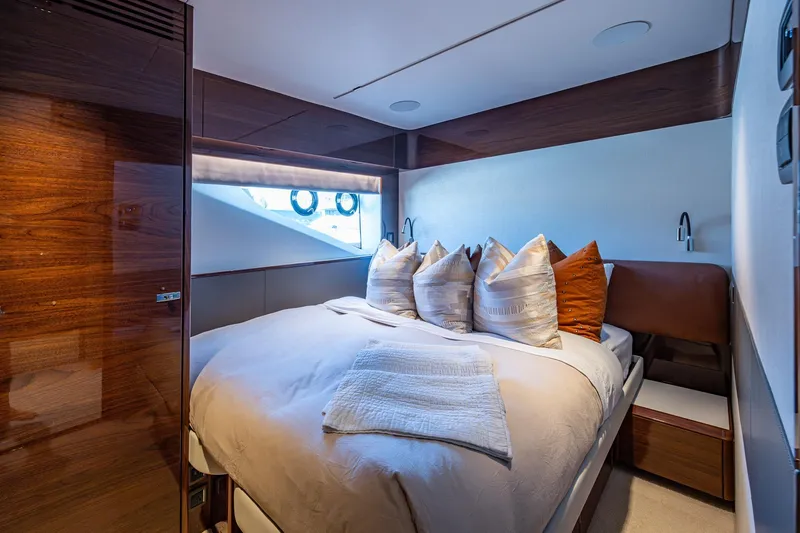 Slide: The Image of Luxurious bedroom interior of 2022 Princess X95 yacht with elegant wood finishes. - 140