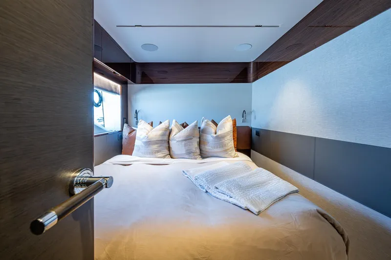 Slide: The Image of Luxurious bedroom interior on 2022 Princess X95 yacht, featuring elegant bedding and modern design. - 142