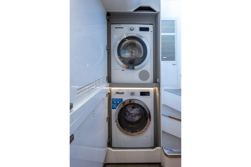 Slide: The Image of Laundry appliances inside 2022 Princess X95 yacht, featuring modern washer and dryer. - 159