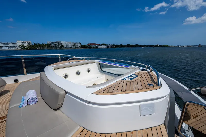 Slide: The Image of Luxurious 2022 Princess X95 yacht with jacuzzi on deck, overlooking serene waters. - 23