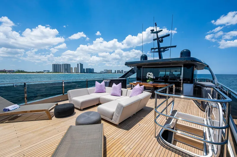 Slide: The Image of Luxurious 2022 Princess X95 yacht deck with modern seating, ocean view, and city skyline. - 60