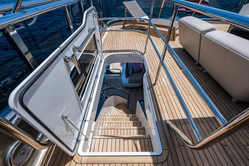 Slide: The Image of Luxurious 2022 Princess X95 yacht deck with open hatch and elegant seating area. - 72