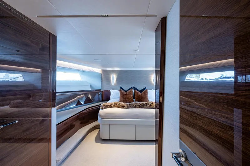 Slide: The Image of Luxurious interior of 2022 Princess X95 yacht bedroom with elegant wood finishes. - 93