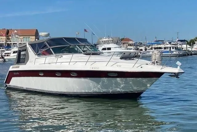 The Image of 1992 Regal Commodore 400 boat docked at marina, featuring sleek design and spacious cabin. - 0