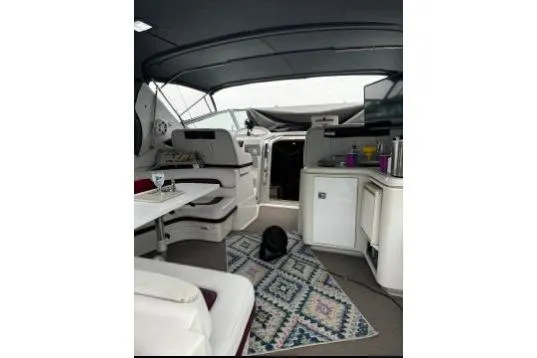Slide: The Image of Interior of 1992 Regal Commodore 400 yacht with seating, table, and kitchenette. - 11
