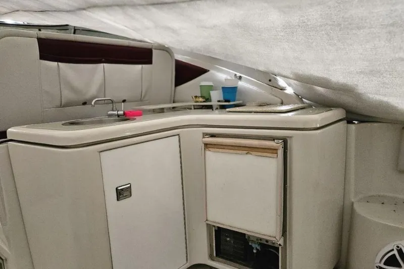 Slide: The Image of 1992 Regal Commodore 400 interior with beige leather seating and compact dining table. - 14