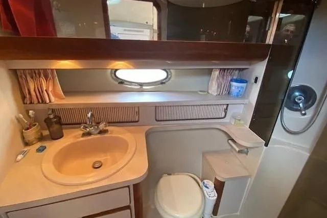 Slide: The Image of 1992 Regal Commodore 400 boat stored outdoors, covered with tarp and snow. - 2