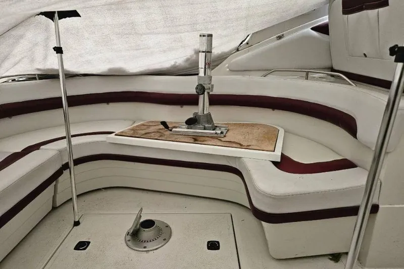 Slide: The Image of Interior of a 1992 Regal Commodore 400 boat with wooden flooring and seating area. - 20