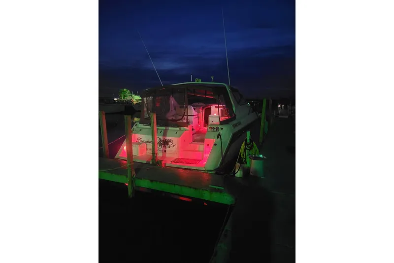 Slide: The Image of 1992 Regal Commodore 400 boat docked at night with red lighting. - 21