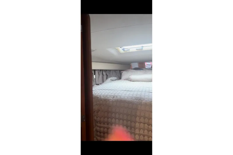 Slide: The Image of Cozy cabin interior of 1992 Regal Commodore 400 yacht with skylight and plush bedding. - 22