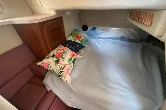 Slide: The Image of Interior of a 1992 Regal Commodore 400 boat with white and maroon seating. - 5