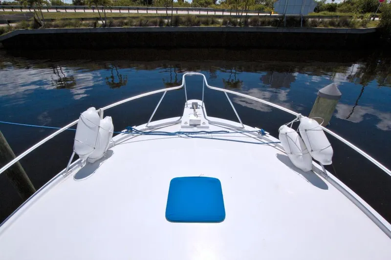 Slide: The Image of 1998 Luhrs 36 Convertible yacht cruising on a scenic waterway. - 10