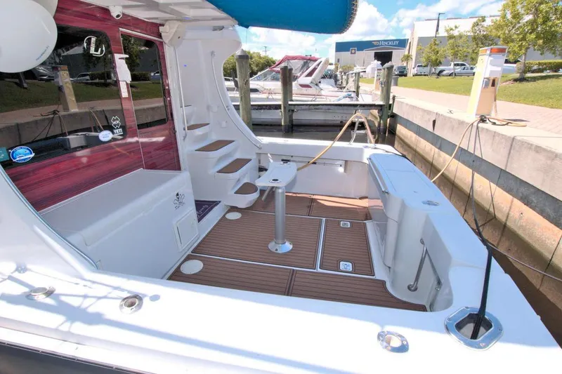 Slide: The Image of 1998 Luhrs 36 Convertible yacht deck with stairs and fishing chair. - 14