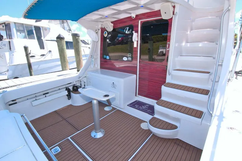 Slide: The Image of Bow view of 1998 Luhrs 36 Convertible yacht cruising on a calm river. - 16