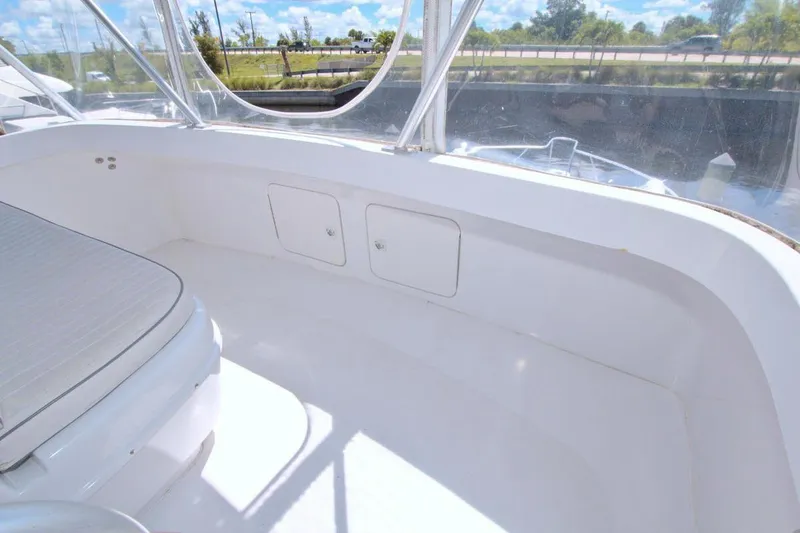 Slide: The Image of 1998 Luhrs 36 Convertible yacht cruising on a calm blue waterway under clear skies. - 19
