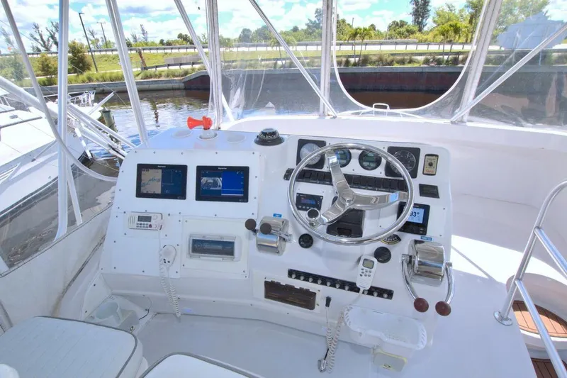 Slide: The Image of 1998 Luhrs 36 Convertible yacht deck with clear enclosure and seating. - 23