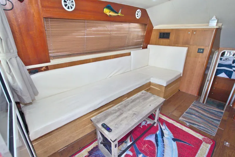 Slide: The Image of 1998 Luhrs 36 Convertible boat helm with clear canopy and waterway view. - 28