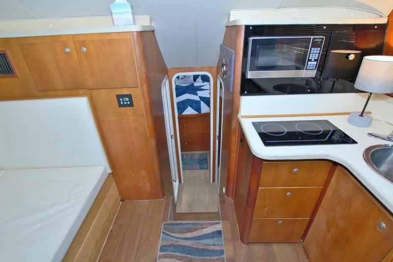 Slide: The Image of Interior of 1998 Luhrs 36 Convertible yacht with kitchen and entertainment area. - 32