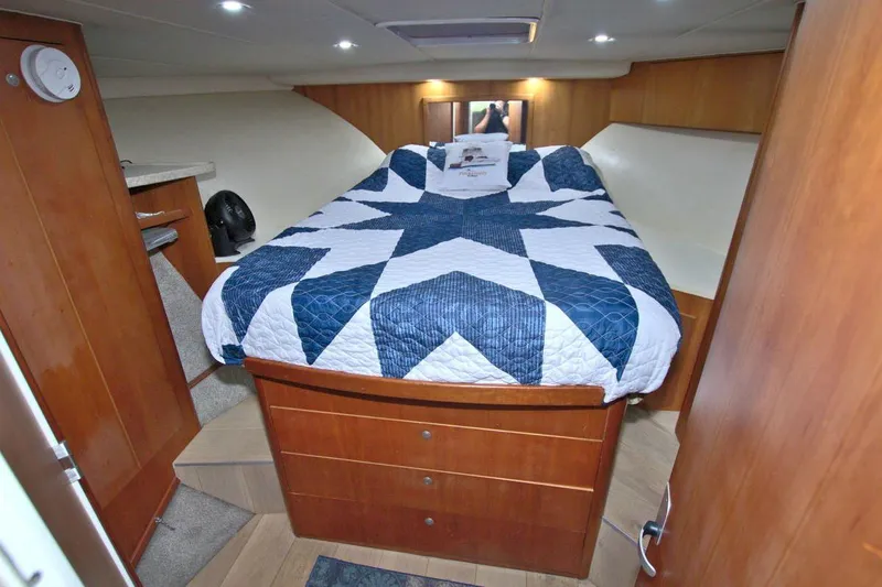Slide: The Image of Interior of 1998 Luhrs 36 Convertible yacht with white seating and wooden accents. - 36