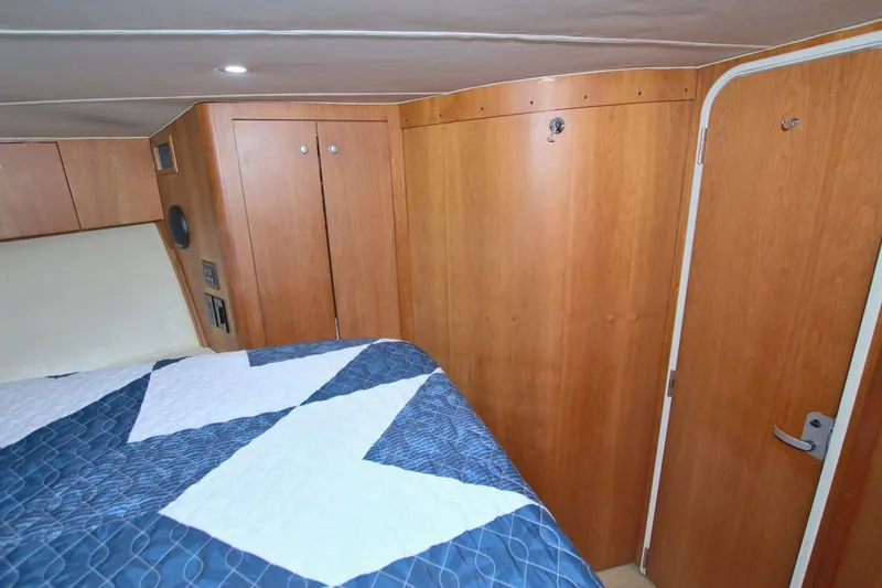 Slide: The Image of Storage area inside 1998 Luhrs 36 Convertible boat with life preserver and vacuum. - 38