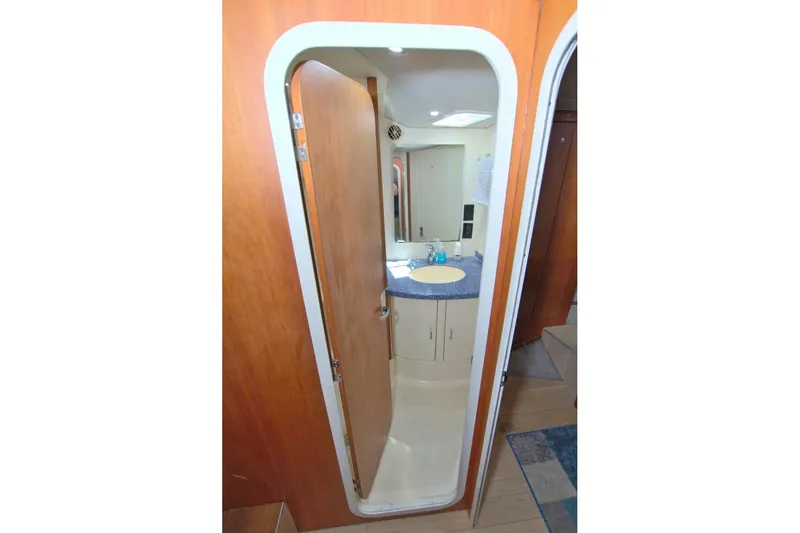 Slide: The Image of 1998 Luhrs 36 Convertible yacht bathroom with wooden door and modern sink. - 42