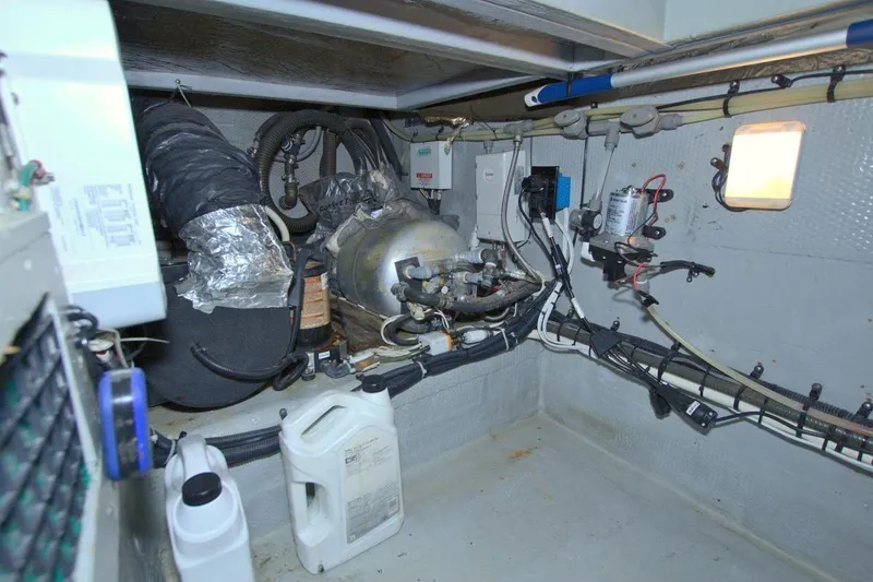 Slide: The Image of 1998 Luhrs 36 Convertible cabin with quilted bedspread and wooden cabinetry. - 46