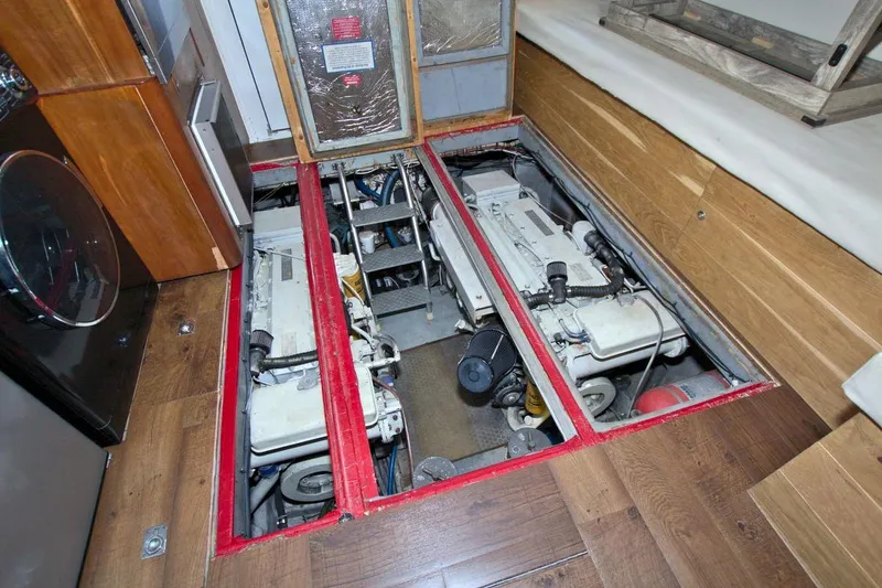 Slide: The Image of 1998 Luhrs 36 Convertible cabin interior with bed, wooden cabinets, and small TV. - 47