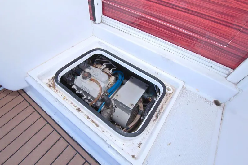 Slide: The Image of Engine room of 1998 Luhrs 36 Convertible boat, showcasing dual engines and wooden flooring. - 56