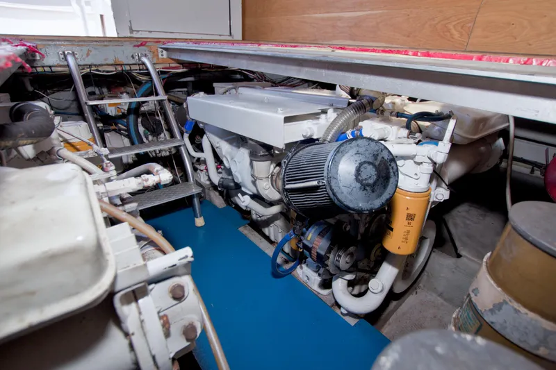 Slide: The Image of Engine room of 1998 Luhrs 36 Convertible boat, showcasing mechanical components and ladder. - 60