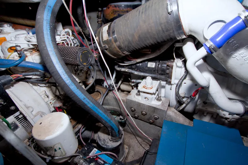 Slide: The Image of Engine compartment of a 1998 Luhrs 36 Convertible boat, showing hoses and components. - 62