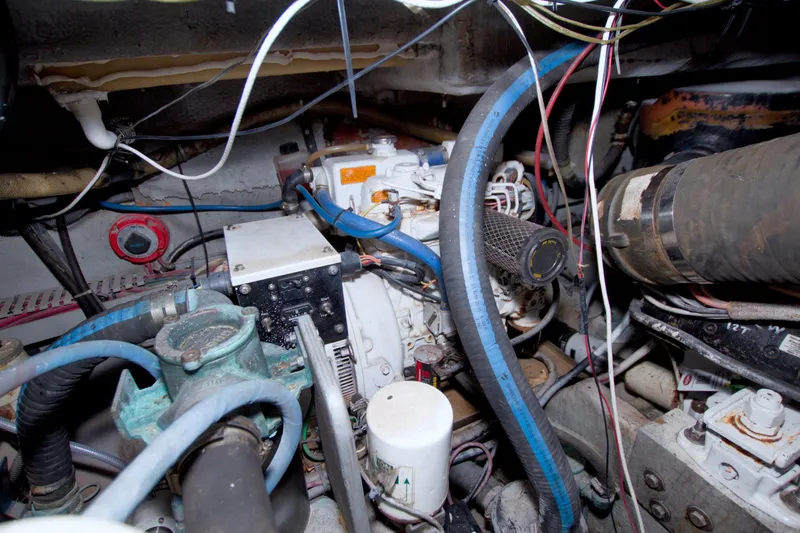 Slide: The Image of Engine room of a 1998 Luhrs 36 Convertible boat, showcasing mechanical components and wiring. - 63
