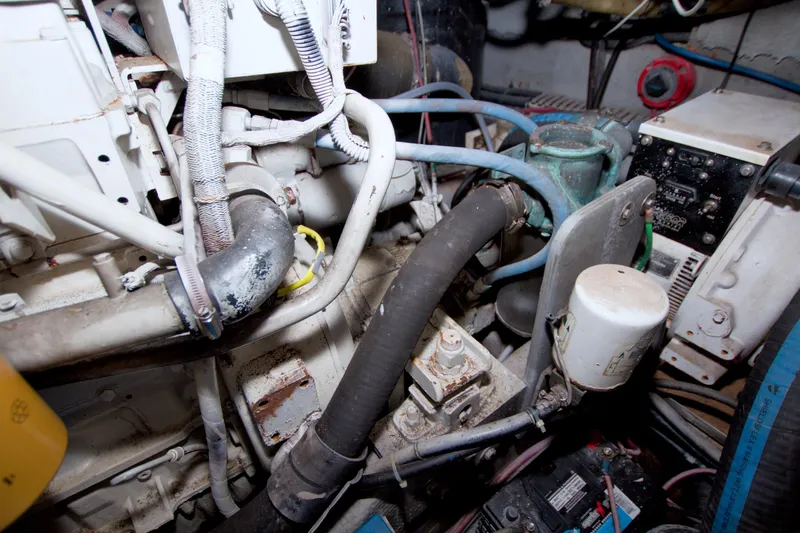 Slide: The Image of Engine room of a 1998 Luhrs 36 Convertible boat, showing various mechanical components. - 65