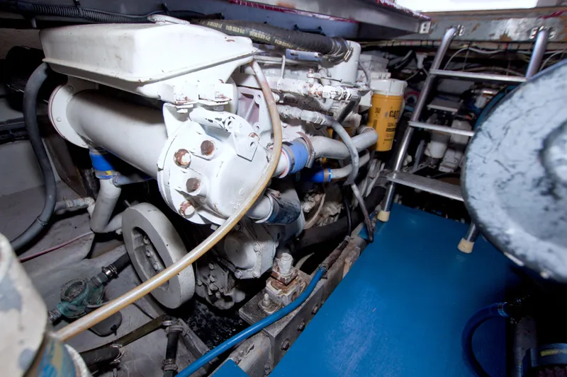 Slide: The Image of Engine room of 1998 Luhrs 36 Convertible boat, showcasing mechanical components and ladder. - 67