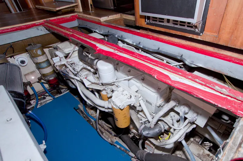 Slide: The Image of Engine room of 1998 Luhrs 36 Convertible boat, showcasing mechanical components and piping. - 68