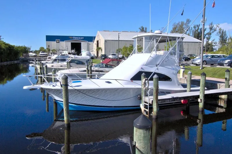 Slide: The Image of 1998 Luhrs 36 Convertible yacht docked at marina, clear blue sky. - 73